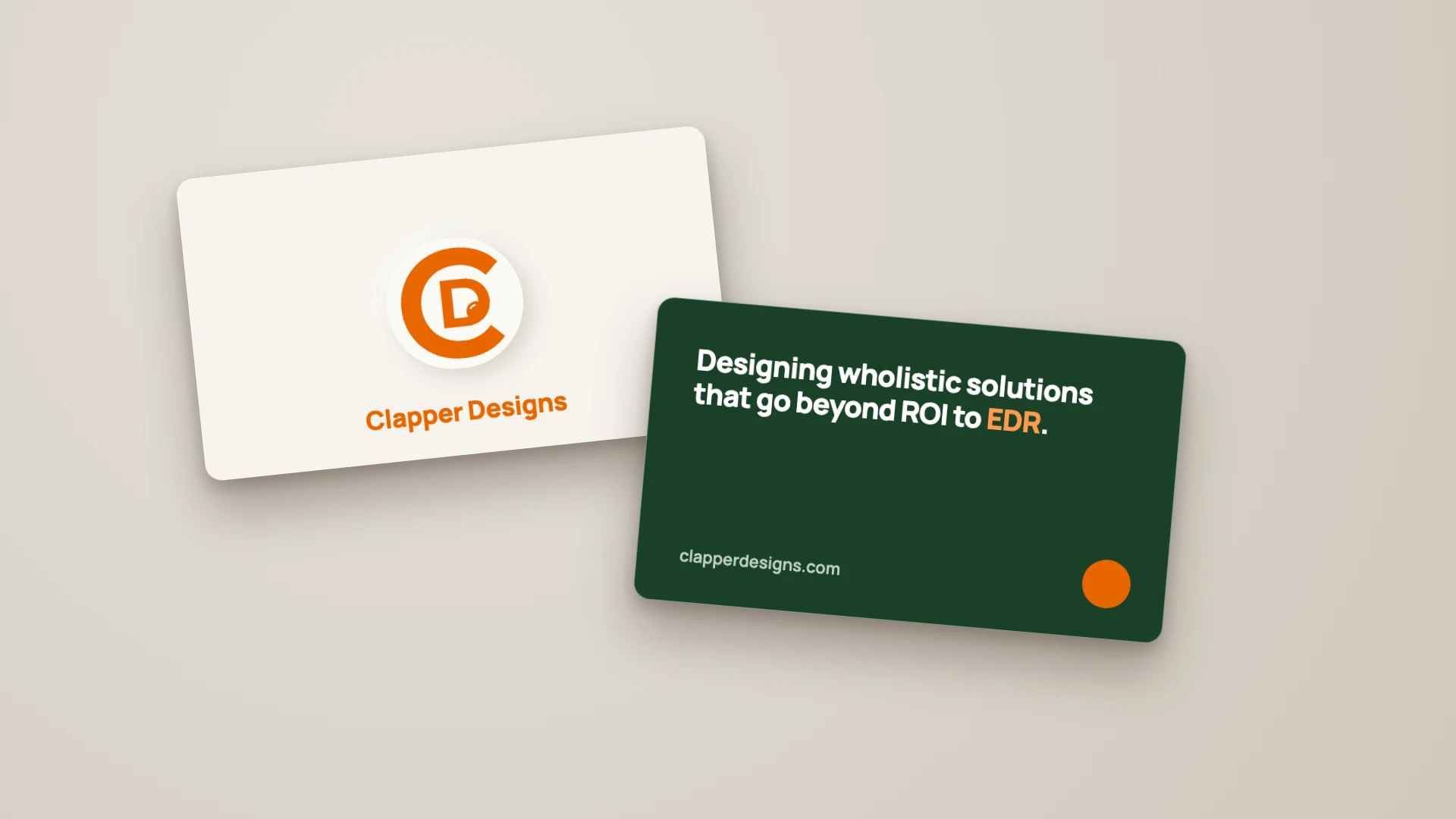 A mockup of two Clapper Designs business cards: a cream front with the mark and name, and a green back with the line Designing wholistic solutions that go beyond ROI to EDR